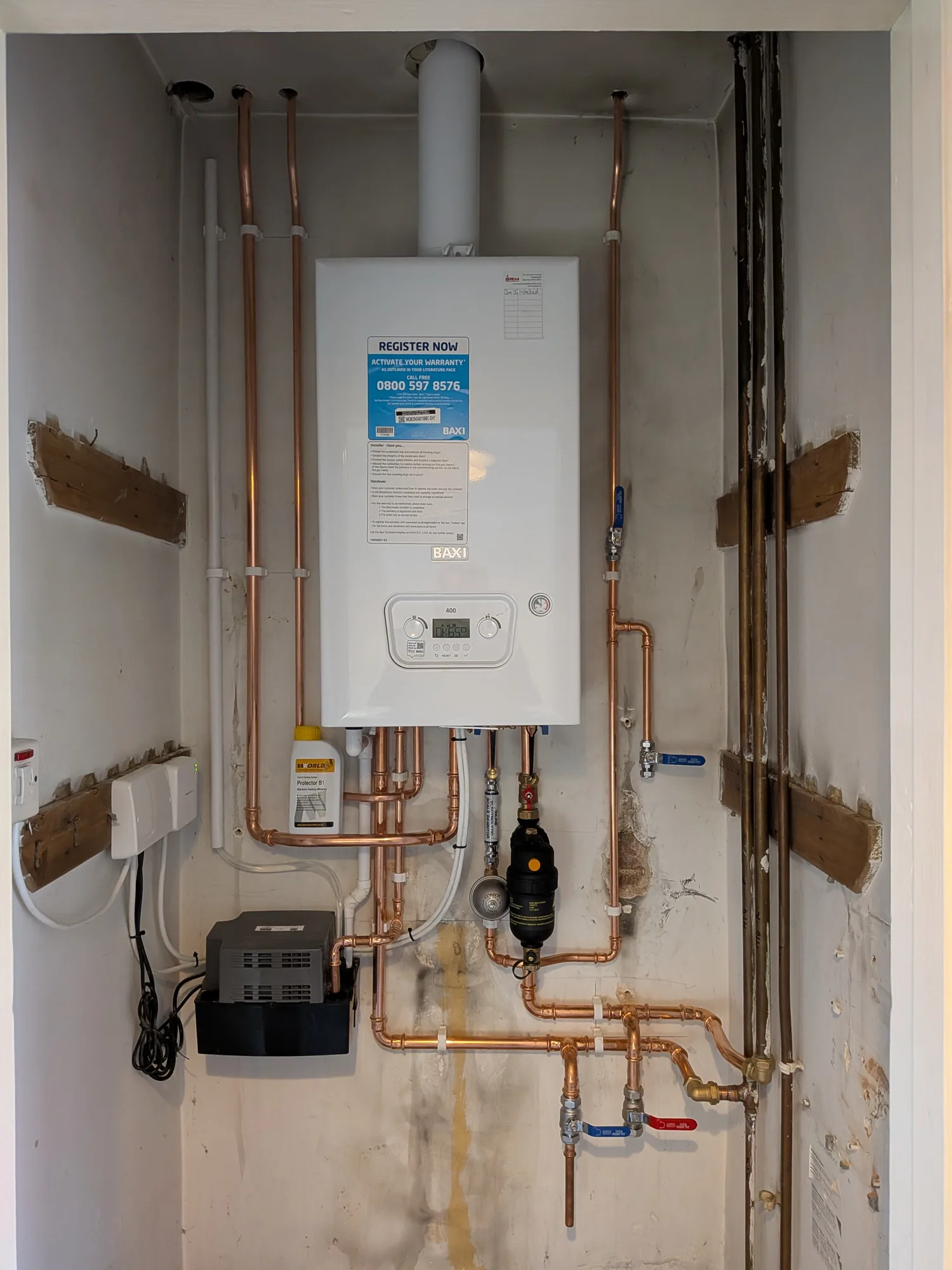 Boiler installed on a timber wall with neat copper first fix