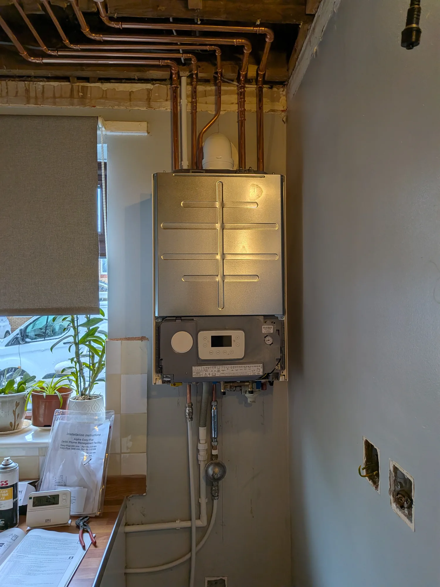 Wall-mounted boiler installation with controls