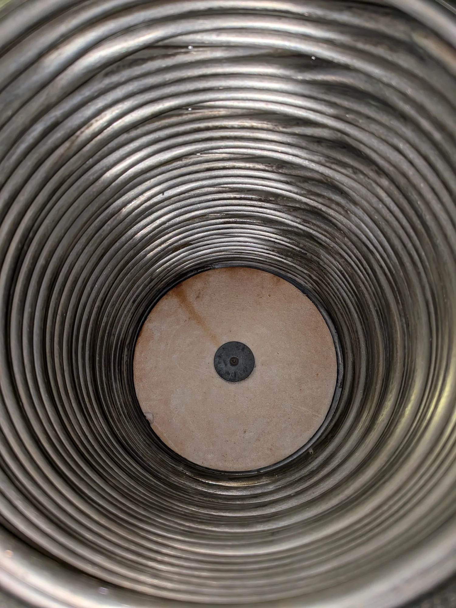 Stainless steel hot water cylinder coil inspected during a service